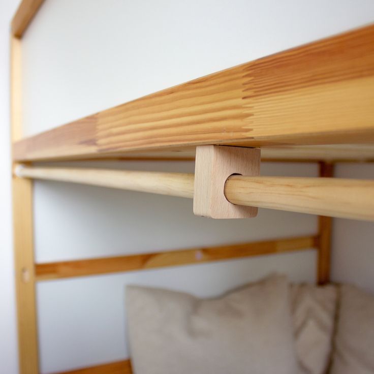 a close up of a wooden bunk bed frame