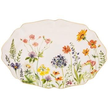 an oval platter with flowers painted on it