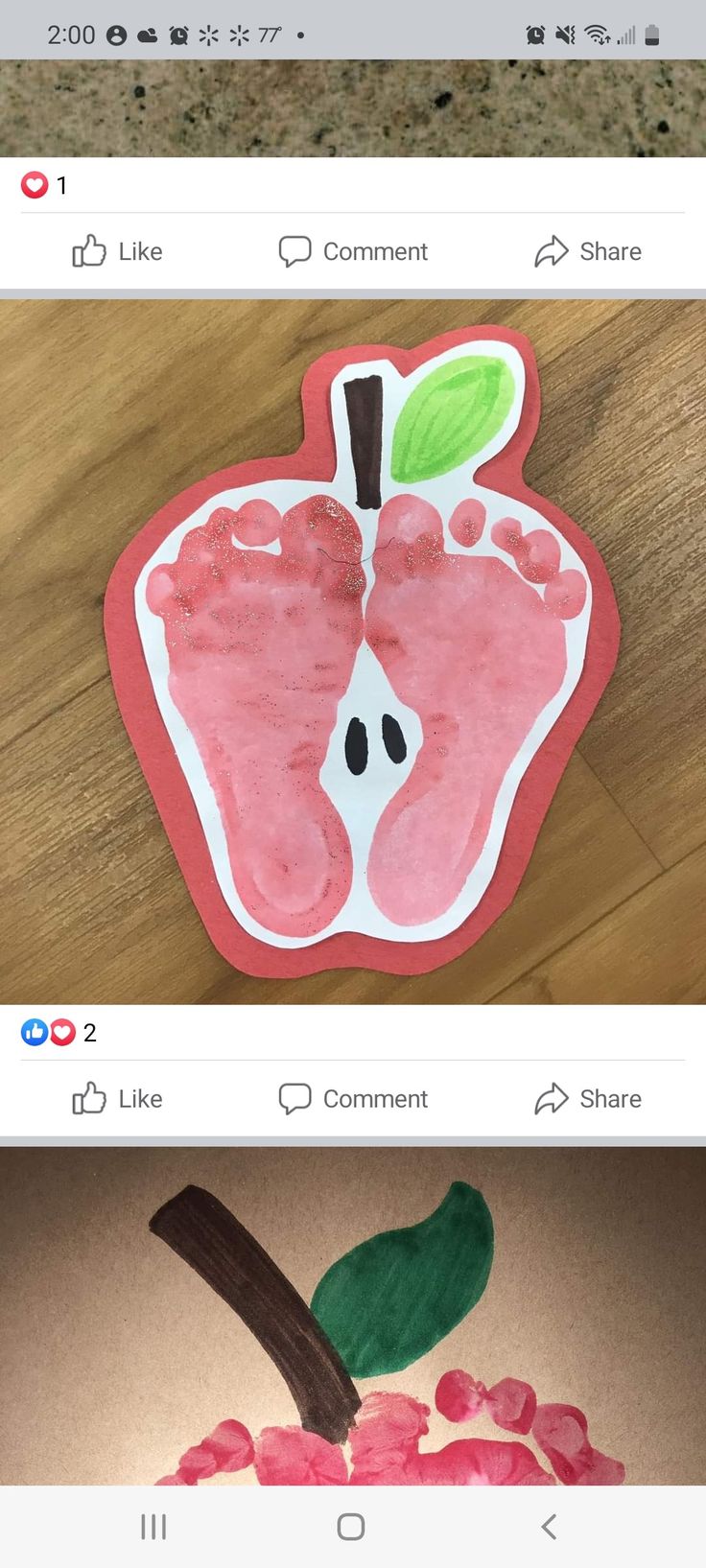 an apple made out of paper on top of a wooden table next to another photo