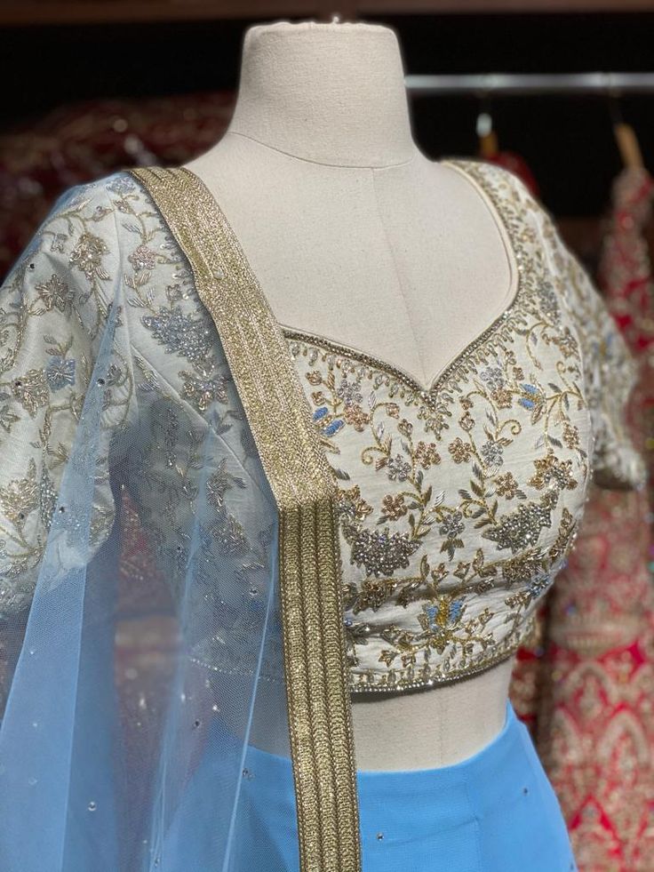 Maya blue stone work lehenga paired with ivory zardozi work blouse and net dupatta. Fabric: Georgette This outfit can be customized in multiple colors and specific to client measurements. 90 days of production time is required and are for bulk orders only! Orders are processed in store only! Final fittings/alterations not included. Minimum Order Quantity- 4 pieces Fitted Blue Tissue Silk Choli, Blue Tissue Silk Sets With Dori Work, Blue Tissue Silk Choli For Designer Wear, Designer Blue Tissue Silk Choli, Blue Tissue Silk Lehenga For Navratri, Blue Tissue Silk Lehenga, Blue Tissue Silk Choli For Reception, Blue Bollywood Anarkali Set In Tissue Silk, Bollywood Style Blue Anarkali Set In Tissue Silk