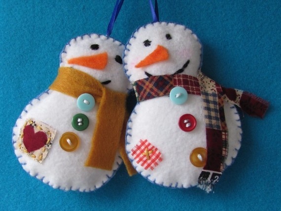 two snowmen are hanging on a blue background