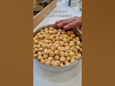 a person holding a metal bowl filled with food