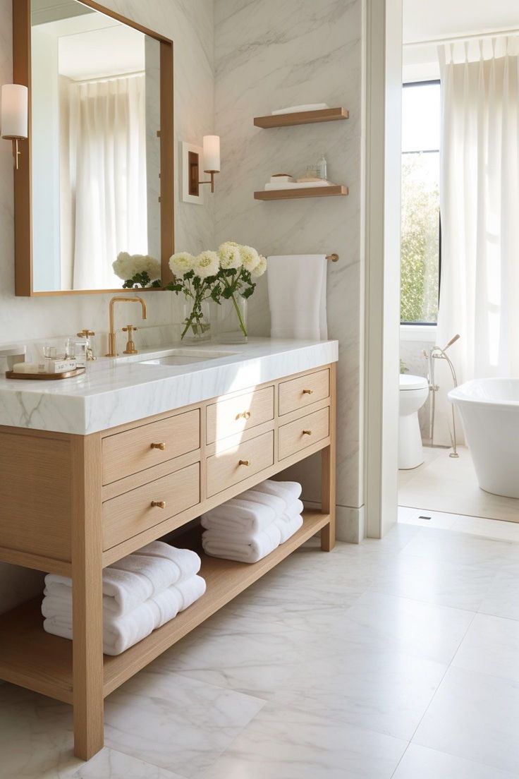 a bathroom with marble counter tops and white towels