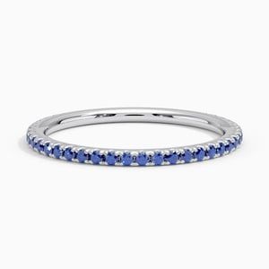 a white gold band with blue sapphire stones