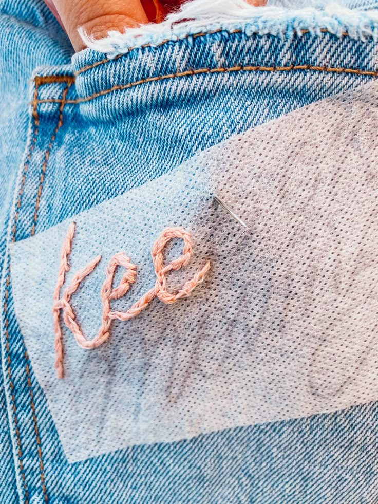 someone's jeans with the word keep written on them, and their hand in the pocket