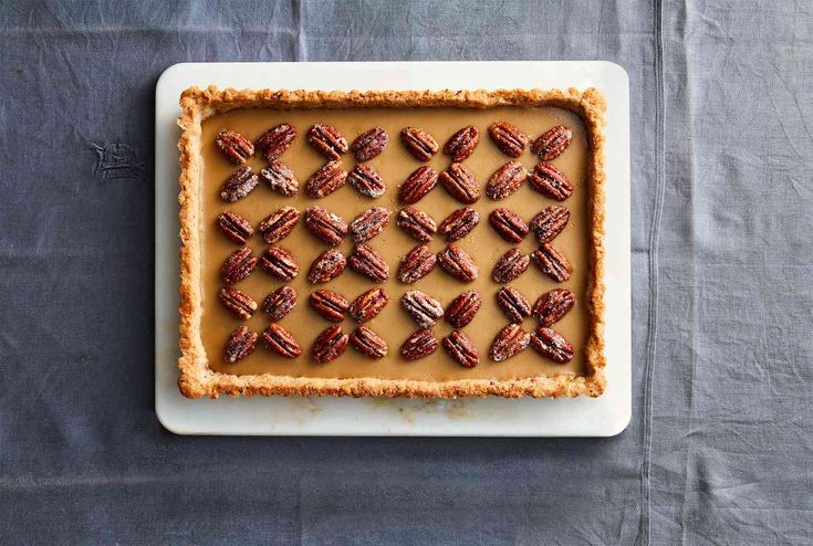 pecans are arranged on top of a tart crust