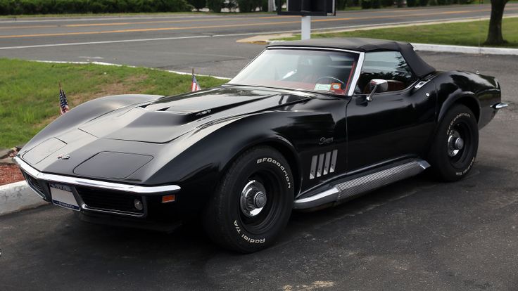 a black sports car is parked on the street