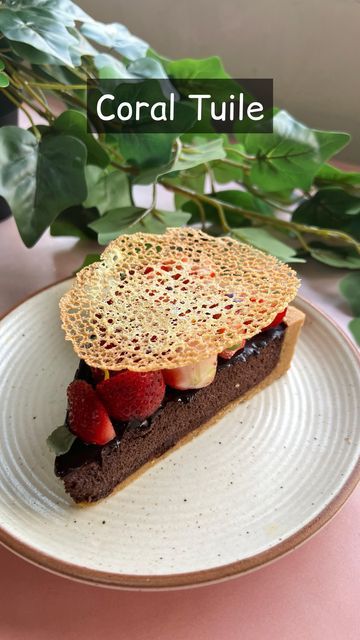 there is a piece of cake with strawberries on it and the words coral tulle above it