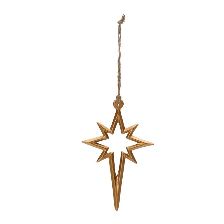 a gold ornament hanging from a rope on a white background, with the shape of a star in the center