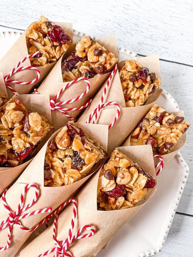 homemade granola bars wrapped in brown paper and candy canes on a white platter