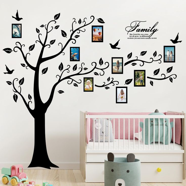 a family tree with pictures on it and birds flying over the branches, in a child's room