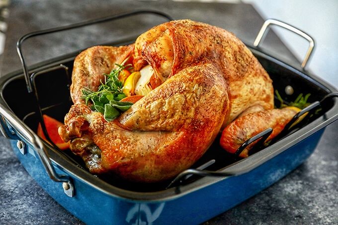 a turkey sitting on top of a white plate