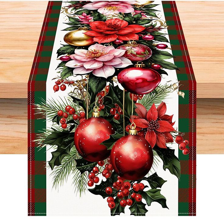 a christmas table runner with poinsettis, holly berries and ornaments on it