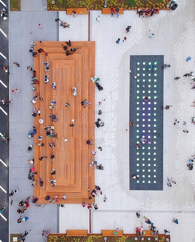 an overhead view of people sitting on benches