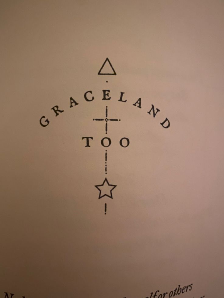 the back side of a white wall with black writing on it that says graceland too