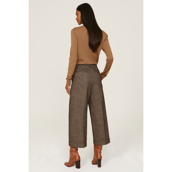 Brown tweed (53% Wool, 47% Cotton). Trousers. Front zipper fly with button closure. 25" inseam. 13.5" rise. Imported. Tweed Pants With Pockets For Fall, Wool Bottoms With Tapered Leg For Fall, Spring Tweed Bottoms With Pockets, Fall Tweed Bottoms With Pockets, Winter Office Brown Bottoms, Tweed Bottoms With Pockets For Work, Chic Wool Bottoms For Fall, Brown Office Pants For Fall, Fall Wool Bottoms With Welt Pockets