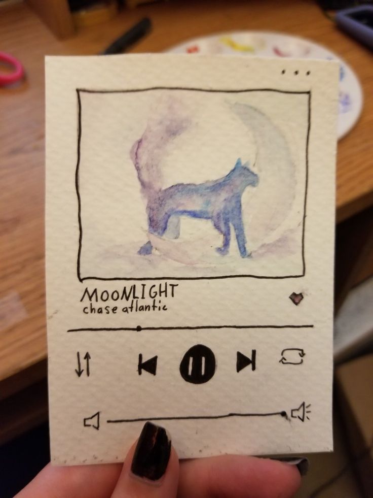 someone holding up a piece of paper with a drawing of a dog on it