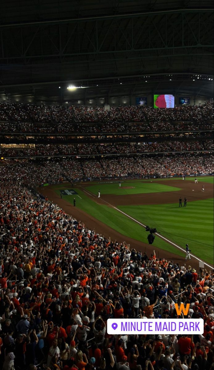 a baseball stadium filled with lots of people watching a game at night, and the words minute maid park written in front of them