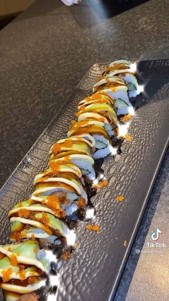 a long piece of food sitting on top of a metal tray