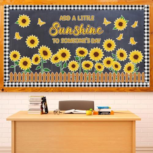 a wooden desk with a blackboard and sunflowers on the wall behind it