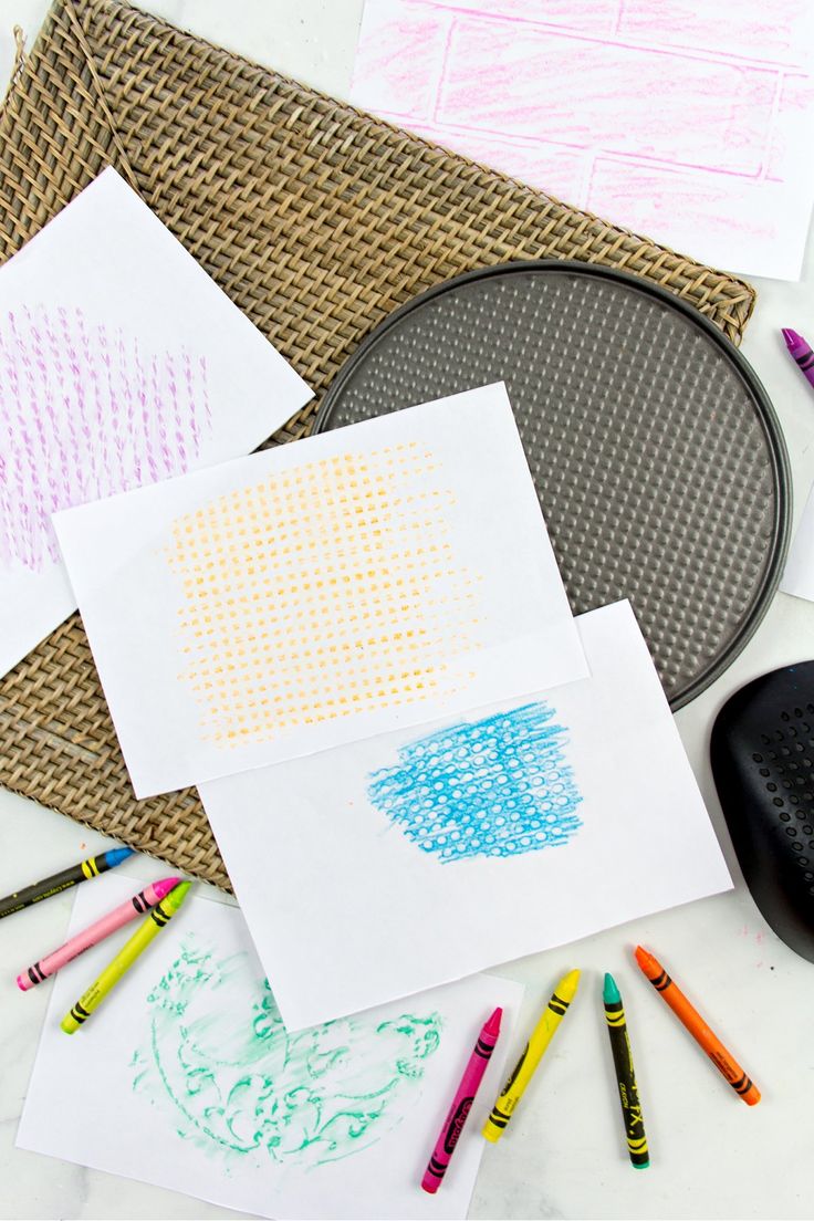 paper and crayons are laid out on the table