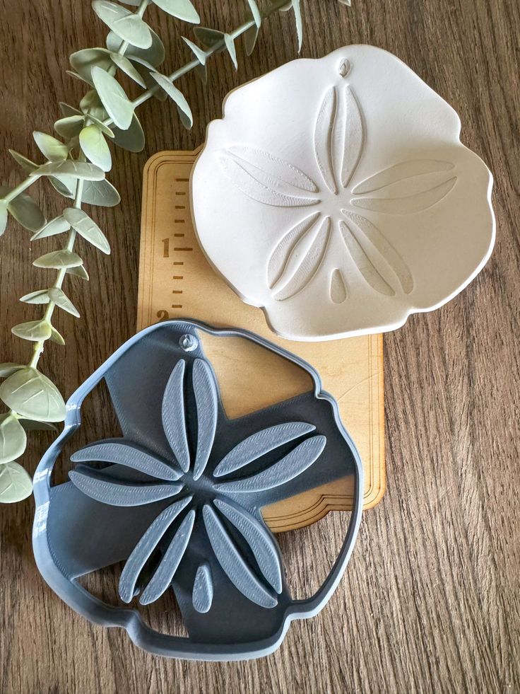 two cookie cutters sitting on top of a wooden table