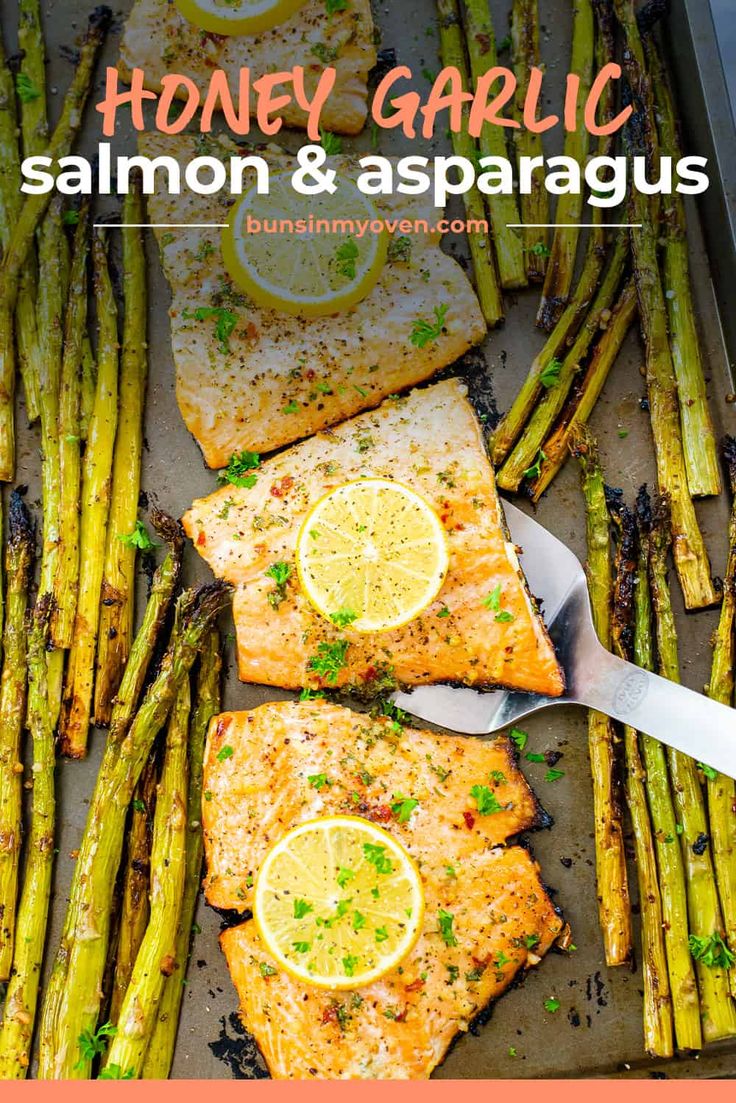 honey garlic salmon and asparagus on a baking sheet with lemons in the background