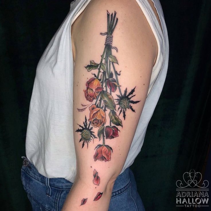 a woman with a flower tattoo on her arm