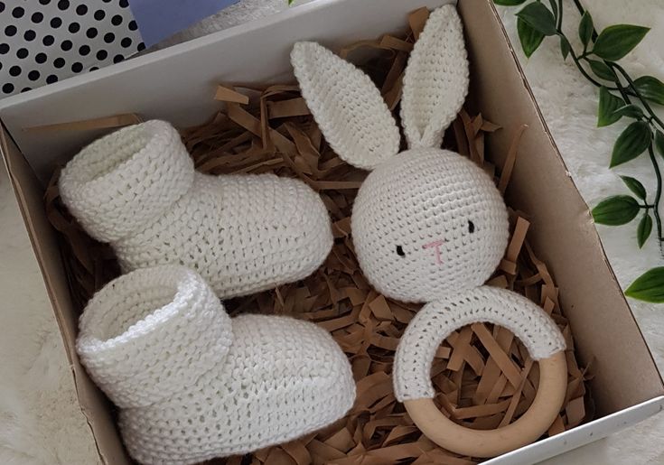 two crocheted stuffed animals in a box