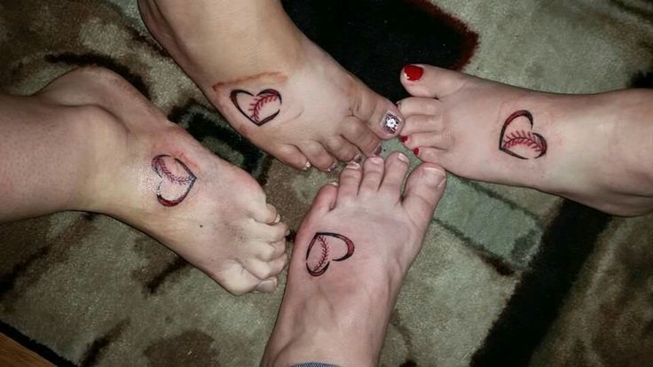 three people with matching tattoos on their feet