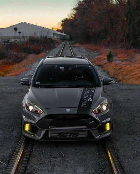 the front end of a car parked on train tracks