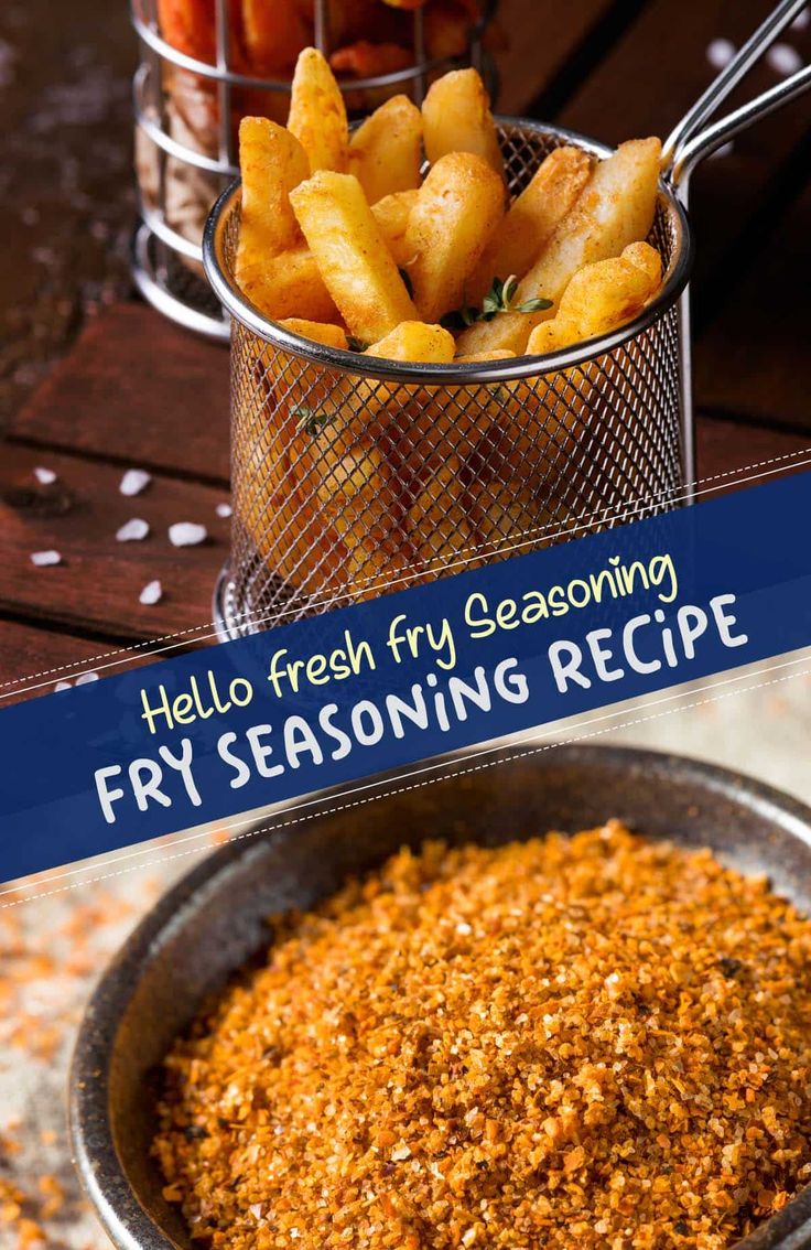 a frying pan filled with fried fries on top of a wooden table next to a basket