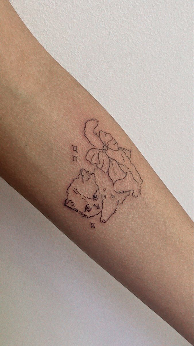 a person with a cat tattoo on their arm