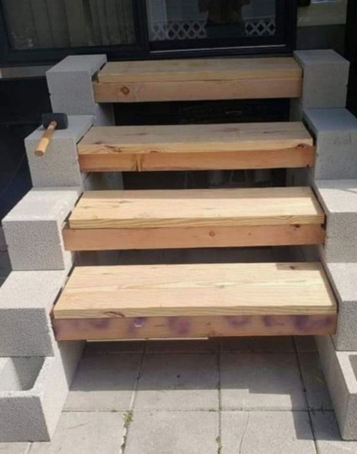 some wooden steps sitting on top of cement blocks