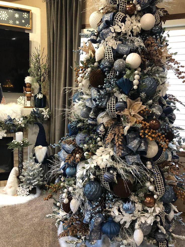 a christmas tree decorated with blue and white ornaments