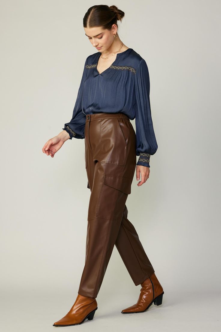 A sleek take on the utility trend. These vegan leather cargo trousers have porkchop pockets at the front, plus streamlined flap pockets at the sides. It's elasticized at the back waistband for added comfort. •Zip fly with button closure •Porkchop pockets at front •Flap pockets at sides •Elasticized back waistband DIMENSIONS •Standard: 28" L of inseam Item number 2370241 Smock Blouse, Leather Trousers, Cargo Trousers, Pork Chops, Item Number, Flap Pocket, Smocking, Vegan Leather, Trousers