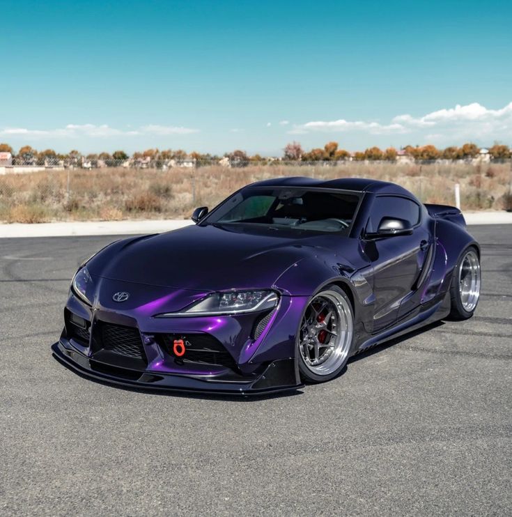 a purple sports car parked on the street