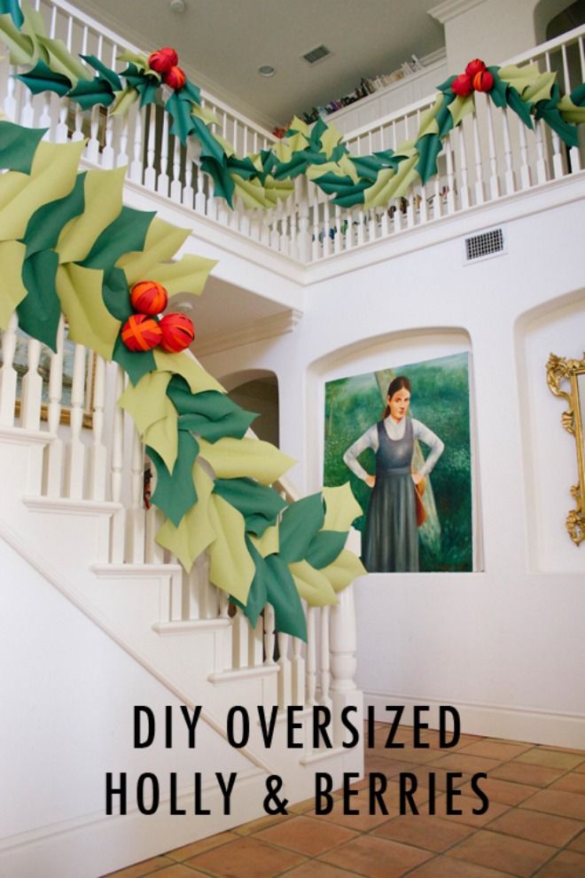 the staircase is decorated with paper flowers and greenery for an elegant christmas display in this home