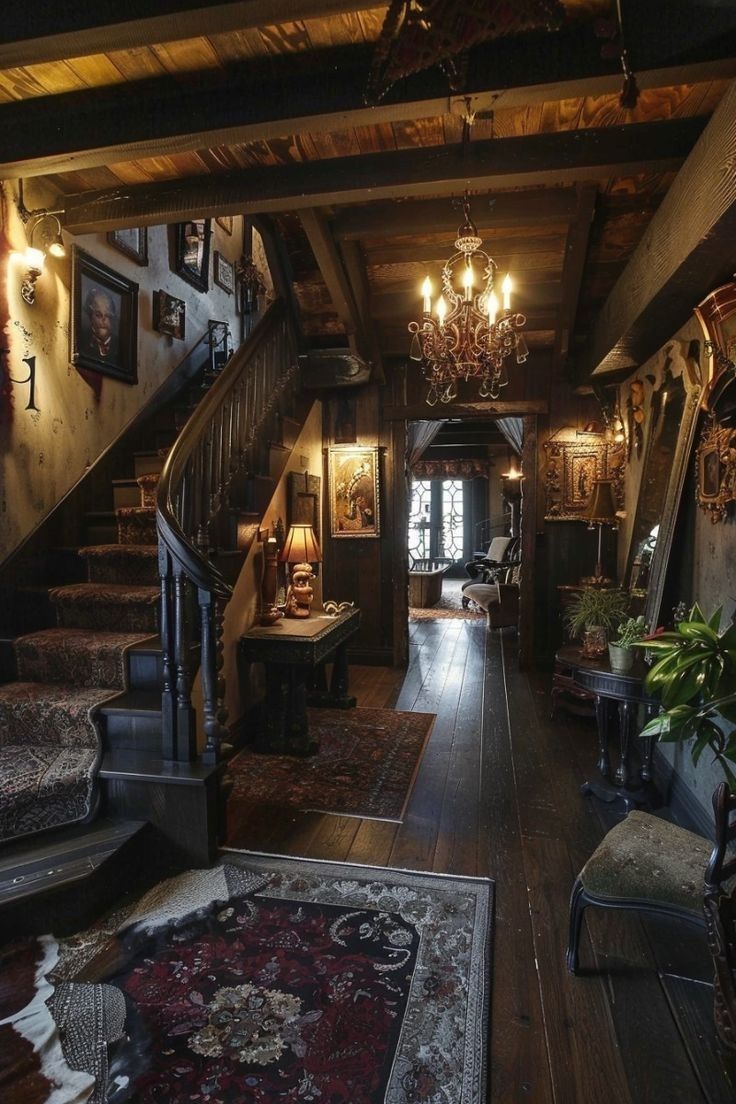 an old fashioned house with stairs and chandelier in the hallway, leading up to the second floor