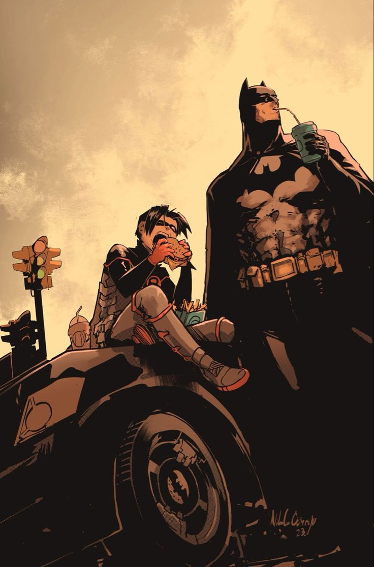 batman and catwoman sitting on the back of a car