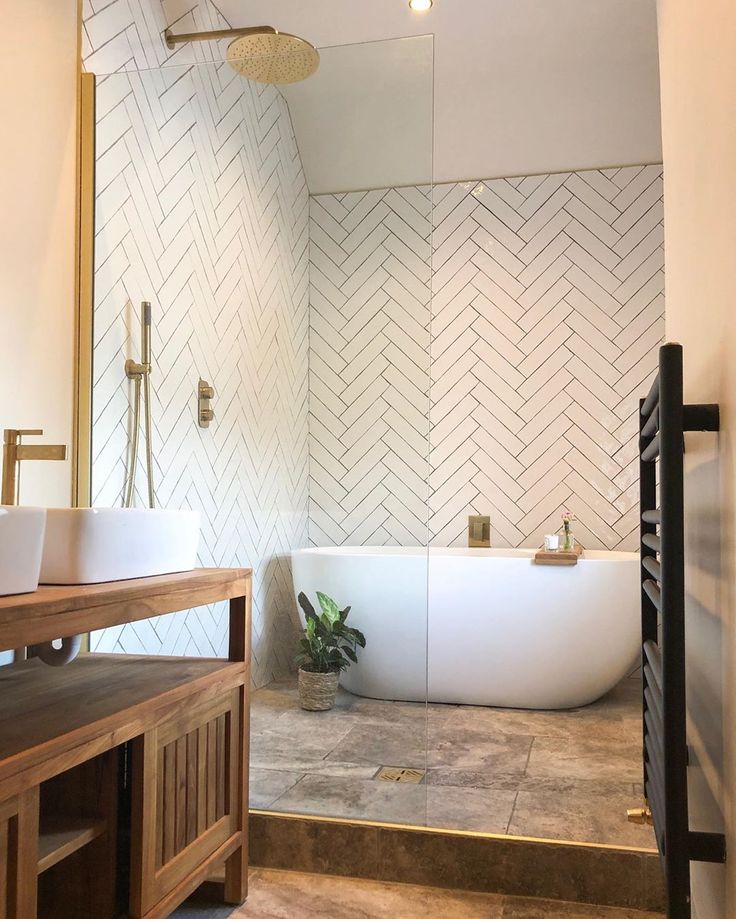 a bathroom with a bathtub, sink and wooden counter top in front of a mirror