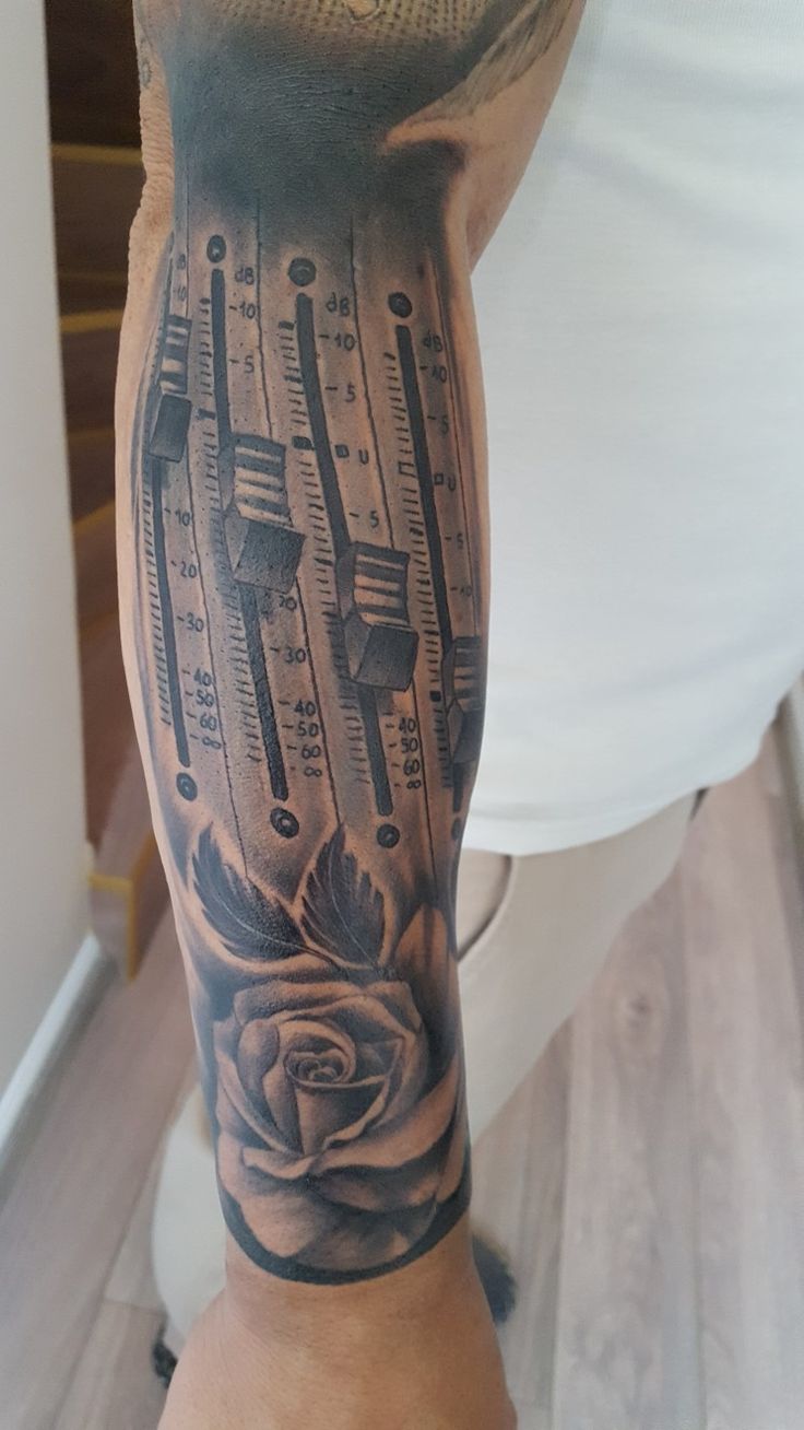 a man with a tattoo on his leg has a rose and thermometers