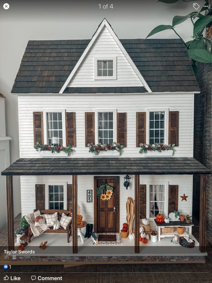 a doll house with furniture and decorations on the front porch is shown in this image