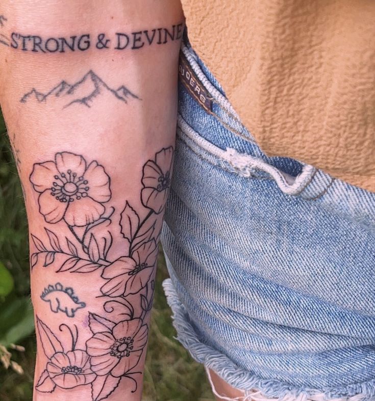 a woman with a tattoo on her arm and the words strong & deviline written in black ink