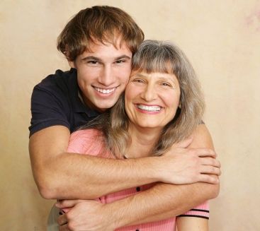 an older woman hugging a younger man