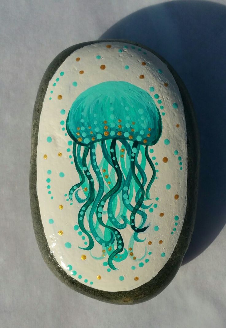 a painted rock with a jellyfish on it