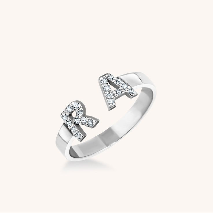 A double dose of sans serif initials covered in pavé diamonds makes a beautiful big little statement. Elegant Personalized Diamond Rings, Classic White Gold Initial Ring With Cubic Zirconia, Classic White Gold Initial Diamond Ring, Classic White Gold Diamond Initial Ring, Silver Initial Ring With Diamond Accents, Personalized White Gold Diamond Ring, Formal Silver Initial Ring With Diamond Accents, Classic Initial Ring With Diamond Accents And Cubic Zirconia, Classic Silver Initial Ring With Diamond Accents