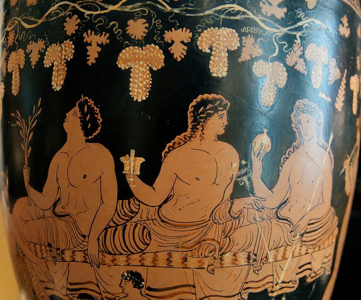 an antique vase with two women sitting on it