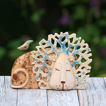 a ceramic animal head sitting on top of a wooden table