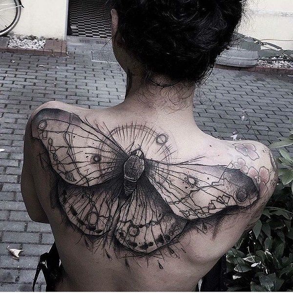 a woman with a butterfly tattoo on her back